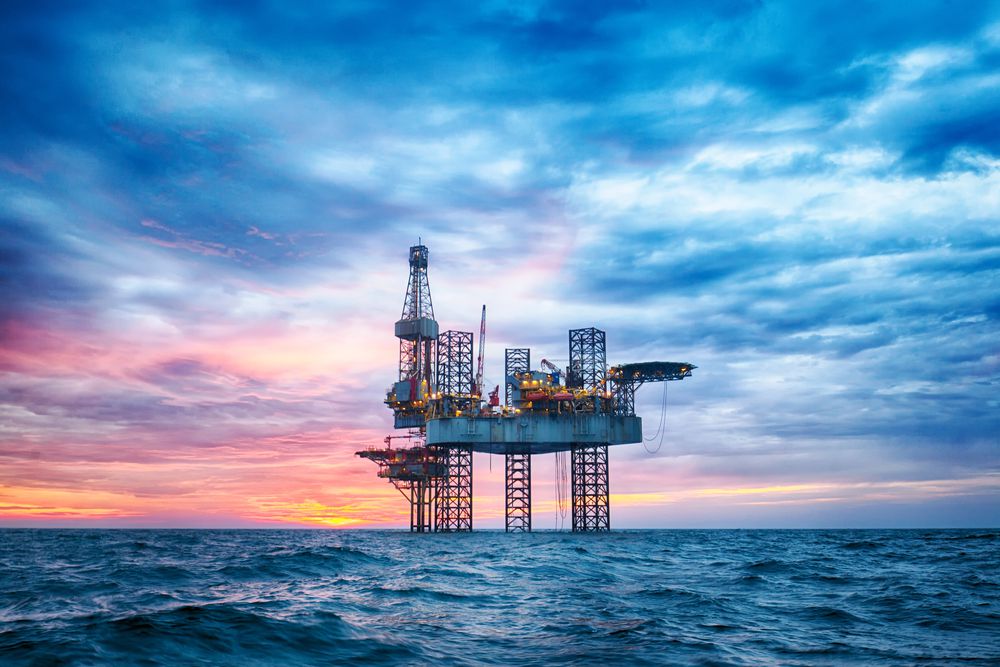 Oil rig with rainbow clouds